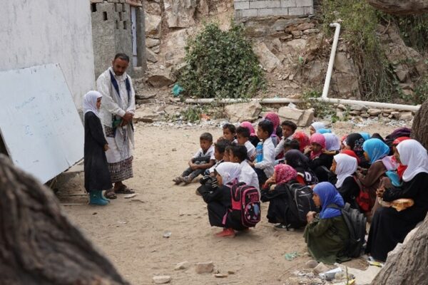 Despite the lack of minimum basics for learning, such as classrooms, desks, chairs, boards, and toilets, students in the Sarar District of Abyan Governorate in Southern Yemen would still rather study under trees than lose their education.

When children are out of school, they face many risks and challenges, which can have dire consequences on both their present and their future. Boys and girls deprived of education are more likely to be trapped in a cycle of poverty and unfulfilled potential for the rest of their lives. They are more likely to be victim of violence, child labor and early marriage.

The prolonged conflict in Yemen has had its toll on children's education and well-being. More than half of the 23.4 million people in need in Yemen are children. During 2022, it has been projected that 2.2 million children suffer from acute malnutrition, including 538,000 children expected to experience severe acute malnutrition.

Over two million school-age Yemeni girls and boys are out of school as poverty, conflict and lack of opportunities disrupt their education. While 2,916 schools across Yemen were destroyed, partially damaged, or utilized for non-educational purposes, the majority of the functional schools suffer from classroom overcrowding, reaching in some areas to more than 80 pupils per classroom.&nbsp; Other challenges schoolchildren face includes the unavailability of toilets, water, electricity, textbooks, and supplementary teaching and learning tools.

To add fuel to the fire, two-thirds of teachers in Yemen &ndash; over 170,000 in total &ndash; have not received a regular salary for more than four years. This puts around four million additional children at risk of disrupted education or dropping out as unpaid teachers quit teaching to find other ways of providing for their families. The Education Cluster in Yemen estimates that 8.5 million need assistance, with about 1.2 million in acute need. And yet as of November 2022, the education sector has only seen under eight percent of the humanitarian funding required to be able to meet the needs.

Read story:&nbsp;https://www.careyemen.org/index.php/media-center-en/stories-blogs/551-from-under-trees-into-classrooms-yemeni-students-remain-determined-to-learn-despite-all-odds.html&nbsp;

&nbsp;

&nbsp;