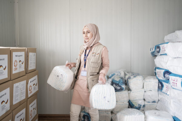 CARE print and online use ONLY&nbsp;(exhibitions, posters, flyers and online and social media channels). Media and partners can purchase a license: www.ostkreuz.de, Christian Pankratz, c.pankratz@ostkreuz.de, +49 (0) 30 - 473 73 930.&nbsp;

&nbsp;

Shorash Abdullah Khalaf, born in Damascus, is one of over 5.6 million men, women and children who were forced to flee their home country Syria over the past ten years of ongoing conflict. While Shorash&rsquo;s husband started his journey towards Europe, Shorash fled to Domiz refugee camp in Northern Iraq. 

&nbsp;

When COVID-19 broke out in Iraq in 2020, the country&rsquo;s already strained health system was hit extremely hard. Hospitals were lacking medical oxygen and personal protective equipment, health staff needed training. CARE immediately adapted its programs and distributed hygiene items such as masks and soap, trained health staff and hygiene promoters to protect people by distributing messages on how to prevent COVID-19. 

&nbsp;

When Shorash saw the job opportunity to work as hygiene promoter for CARE, she immediately applied and quickly became head of the CARE hygiene team. They worked around the clock to support and protect the community in Mam Rashan camp for internally displaced people. 

&nbsp;

&ldquo;Being a refugee makes you act like a hero. My sisters always tell me that I am their role model&rdquo;, she explains. &ldquo;To me, it has always been especially important to help refugee women and girls to understand their bodies and to take care of their hygiene. Women and girls are on their period every month, despite the many difficulties they face while being a refugee. I am very proud that I can support them and at the same time can also help my family with this income.&rdquo;

&nbsp;

Despite her fulfilling work as a CARE hygiene promoter, Shorash has been longing for the moment to reunite with her husband ever since they left Syria. In April 2021, she finally received the letter she has been waiting for so long allowing her to join him in Bregenz, Austria. She recently arrived in Austria and is now doing a lot of paperwork while getting used to her new life. She is eager to celebrate her 30th birthday which happens to be on World Refugee Day, June 20. 

&nbsp;

CARE supports people living in Mam Rashan camp with safe drinking water, the maintenance of sanitation facilities and waste management. To prevent the spread of COVID-19, CARE organizes hygiene awareness raising sessions and distributes hygiene kits. With a special focus on women and girls, CARE also distributes sanitary pads and other hygiene items.&nbsp; 

&nbsp;

To date, CARE has reached over 520,000 people in Iraq.