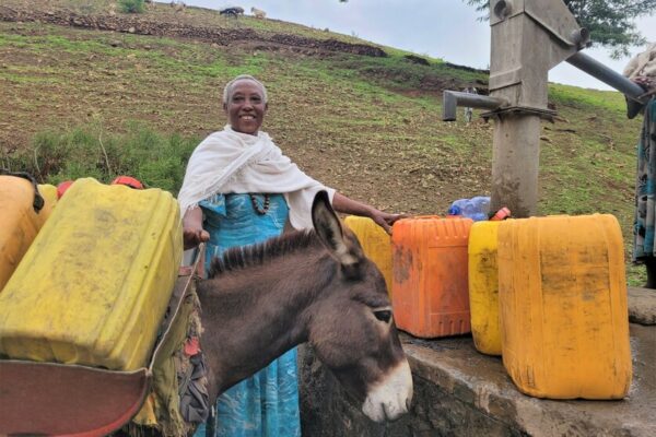Yalga, 70, fetching water at a water pump, installed by the community together with CARE.

Climate change is affecting communities in Ethiopia. The country is facing the worst drought in the last 40 years. Women and girls have to walk long distances to find water. Livestock are dying and the fields are not producing enough crops. Livelihoods are at risk.&nbsp;
&nbsp;
It is the women and girls that need to go and find water. Due to the drought, it can take up to two hours of walking to find a source. Girls drop out of school, because they have to walk the whole day to fetch water for their families.&nbsp;
&nbsp; &nbsp; &nbsp; &nbsp;
After walking for hours, the women and girls find a small water hole or a stream that still has water. The water is dirty. Livestock also drink from it. The water is full of their feces and excrements. &ldquo;Little worms live in the water, that suck the blood out of your mouth. Drinking water from an unprotected source made us very ill. Diarrhea and vomiting are the most common,&rdquo; explains Bosse, 40. Drinking contaminated water full of bacteria has serious health effects that can compromise the immune system severely, cause infections and sometimes even lead to death.&nbsp;
&nbsp; &nbsp;
That is why it is crucial to have access to a protected water source. In water projects, CARE supports the communities by building wells and water pumps close to the villages. The area around the water pump is protected by the community. &ldquo;We plant trees and other plants. With gabions we build barriers to control the water flow. No livestock is allowed to enter this area. Before we had this protected environment, we had enough water for a month. But now the ground water is rising, and we already have enough for six months. We understand the importance and will continue planting more trees to have enough water for the whole year,&rdquo; explains Bosse.


&ldquo;Having access to water changed our community. Women have less household chores and girls can go back to school and receive an education instead of fetching water the whole day. We changed our mindset. Now we treat the trees in the protected environment like our children,&rdquo; reflects Yalga, 70.&nbsp;
